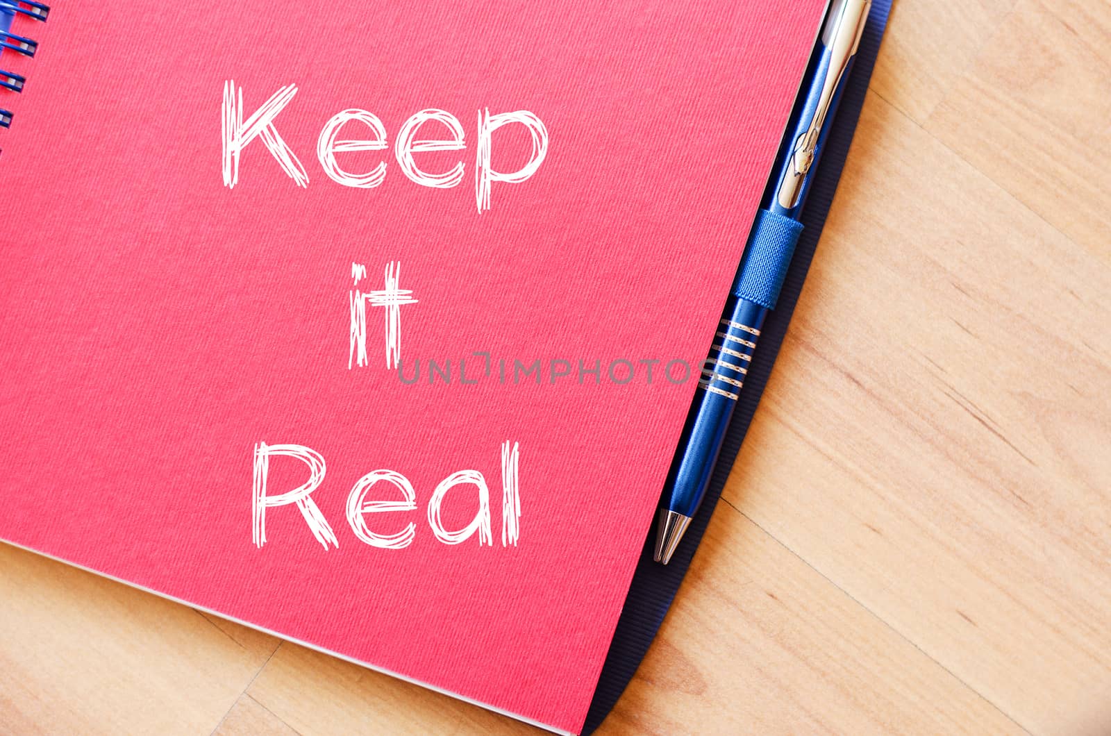 Keep it real text concept write on notebook with pen
