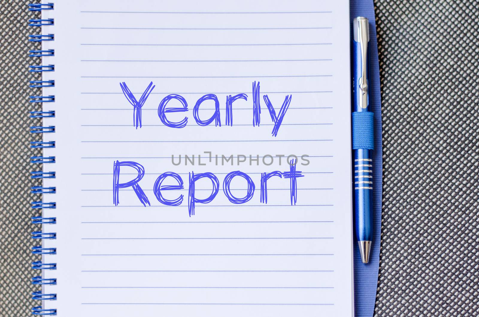 Yearly report text concept write on notebook with pen