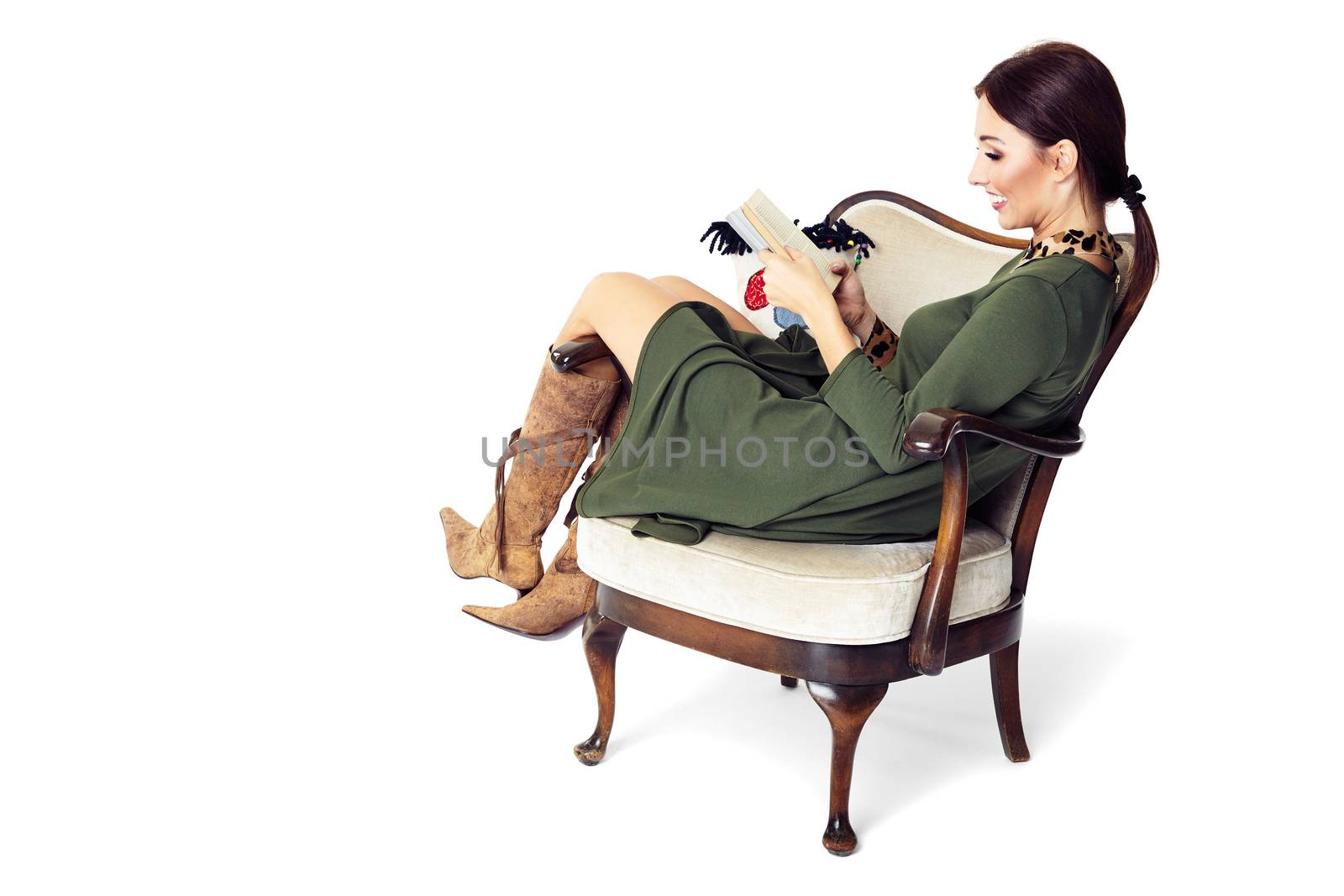 Cheerful woman sitting on chair and reading a book. Isolated on white background.