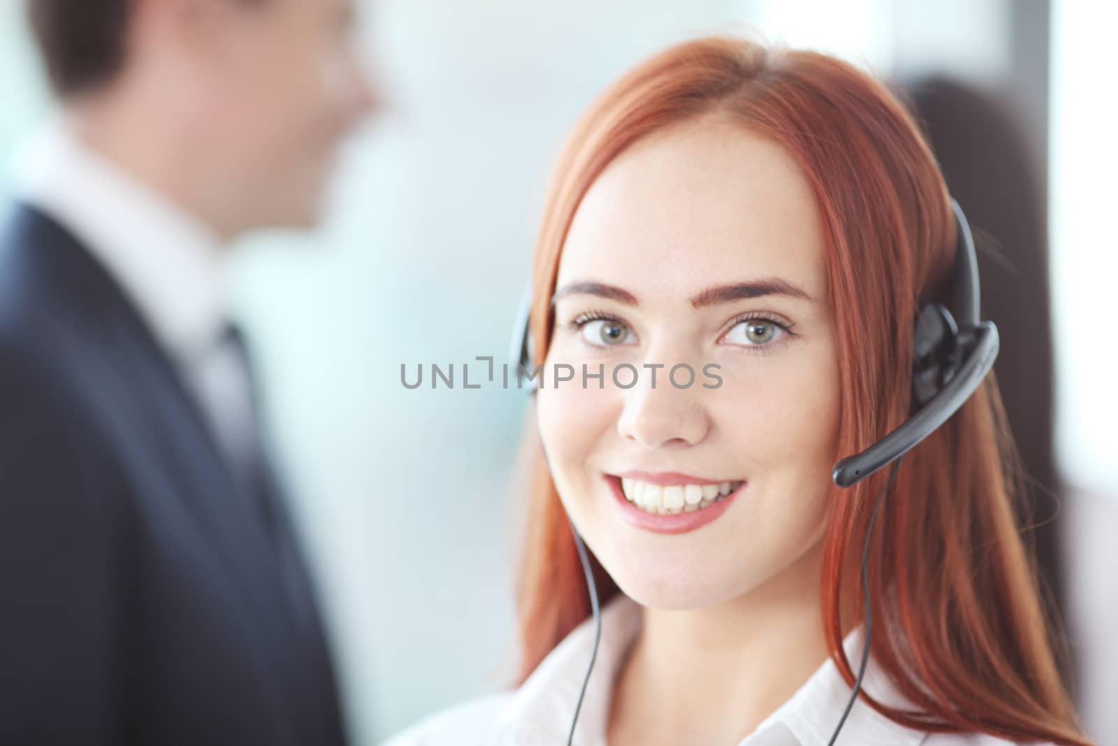 Portrait of a smiling creative businesswoman with earpiece in office by ALotOfPeople