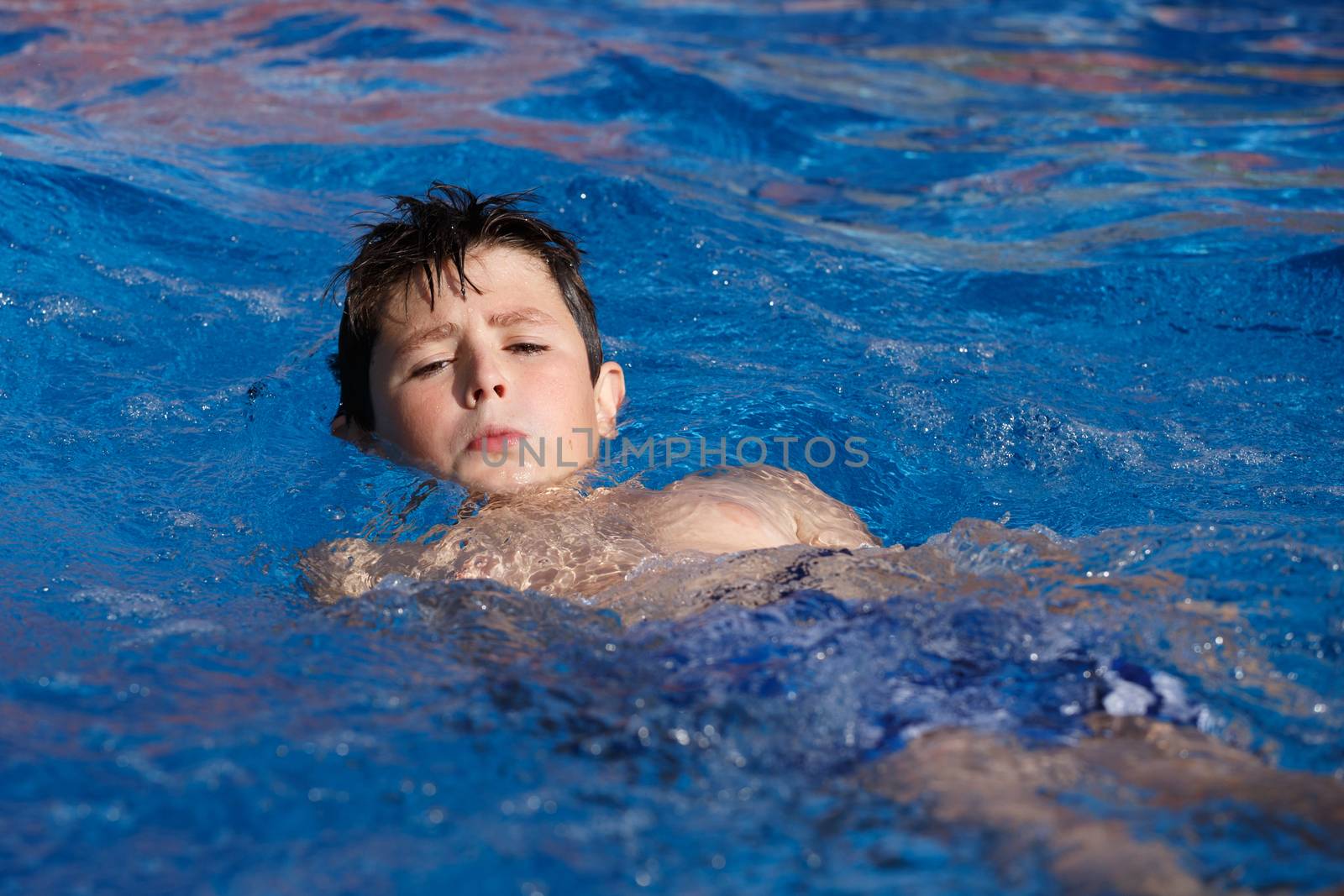 Boy swimm in pool by artush