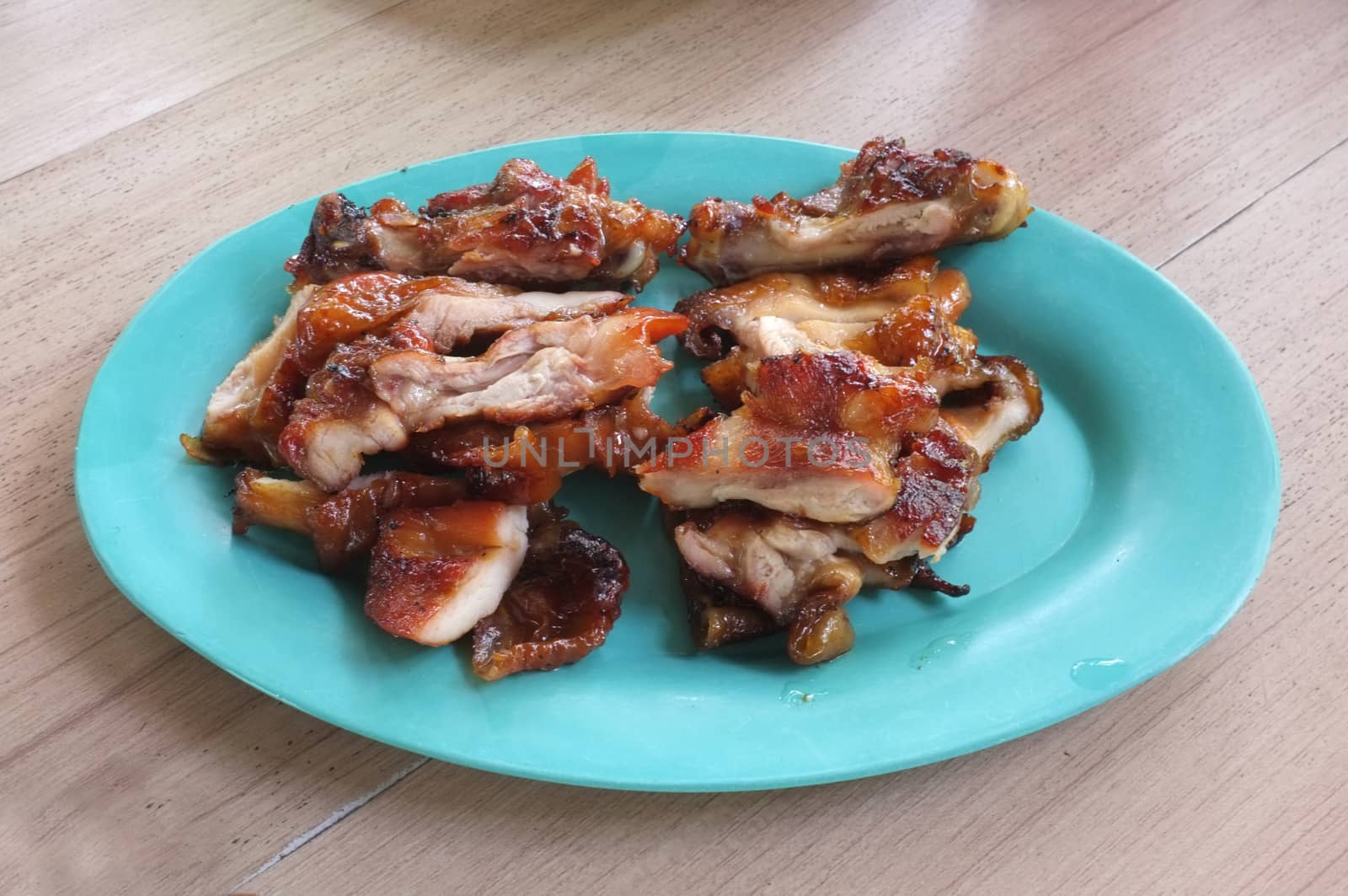 Grilled chicken in plastic dish
