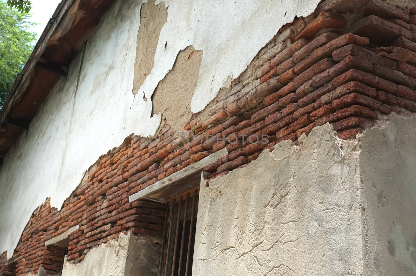 Destroyed concrete and brick wall on old building