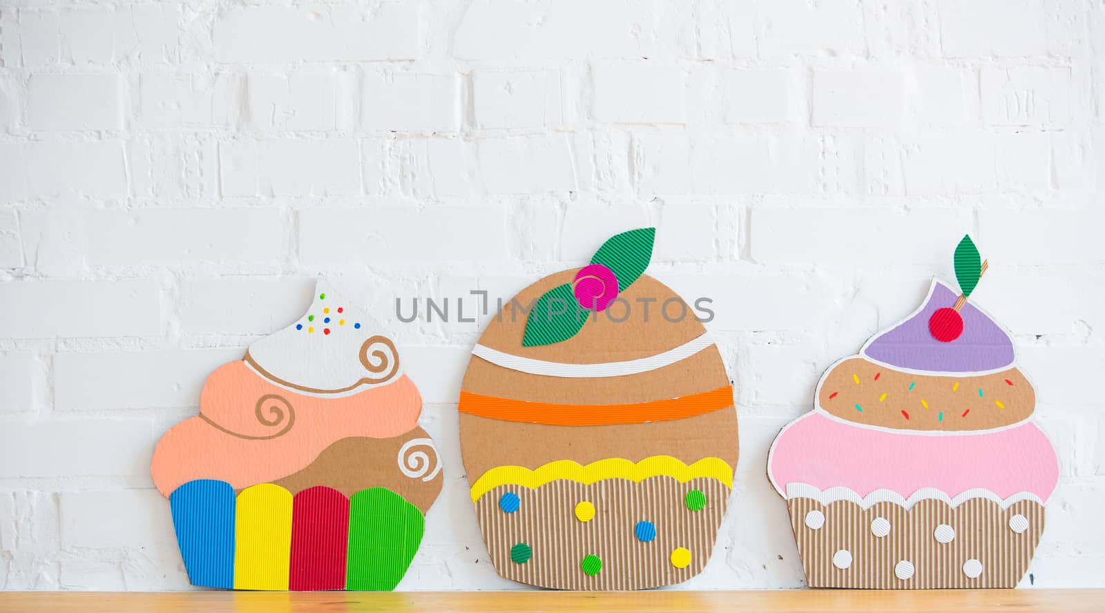 colored cakes handmade of cardboar on white background