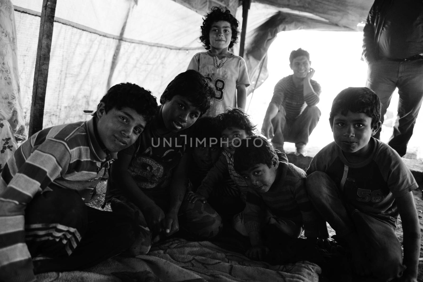 Unnamed  syrian people in unofficial refugee camp in Reayhanli. These people are refugees from Syria and escaped because of long civil war. April 1, 2015; Reyhanli, Turkey