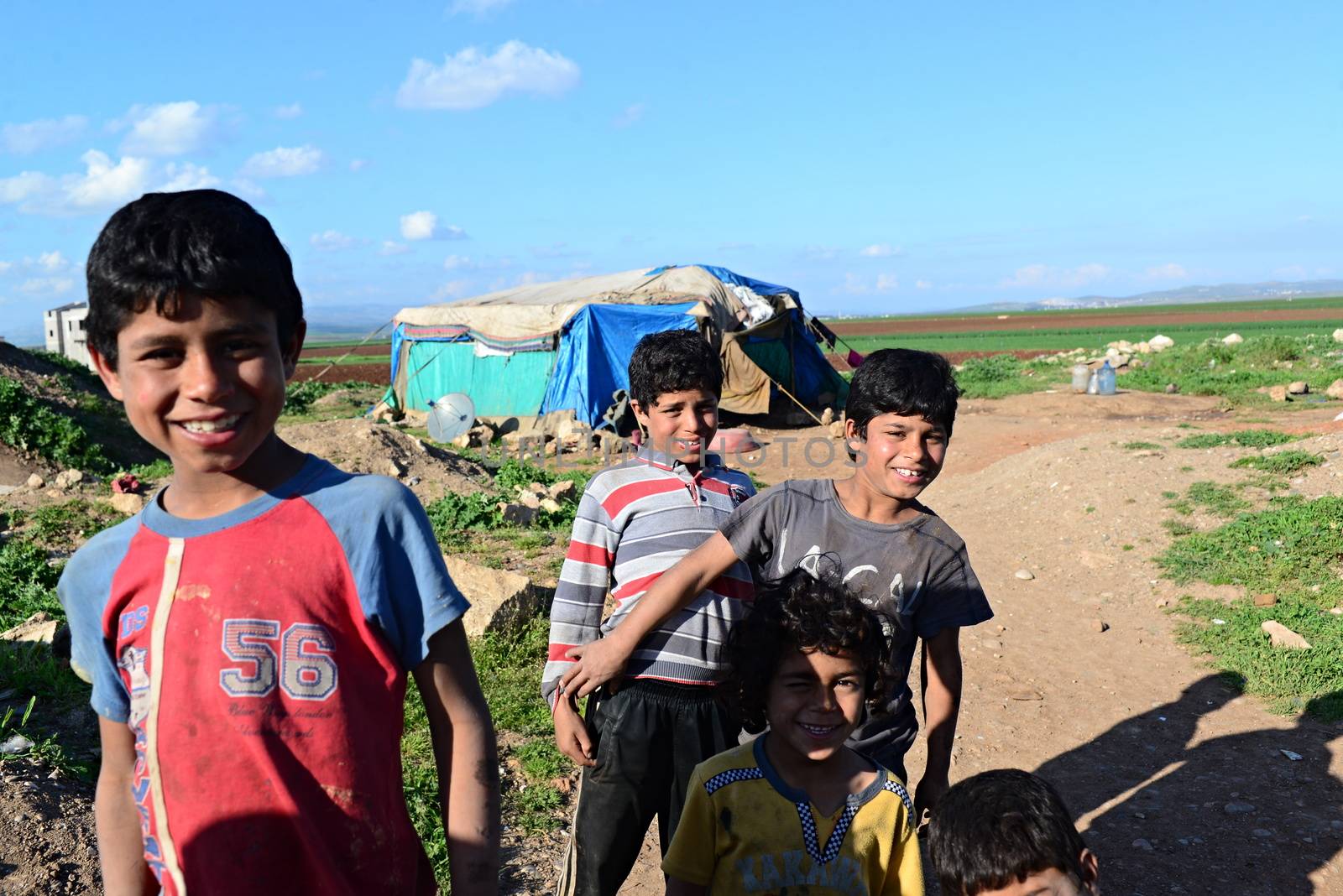 Unnamed  syrian people in unofficial refugee camp in Reayhanli. These people are refugees from Syria and escaped because of long civil war. April 1, 2015; Reyhanli, Turkey