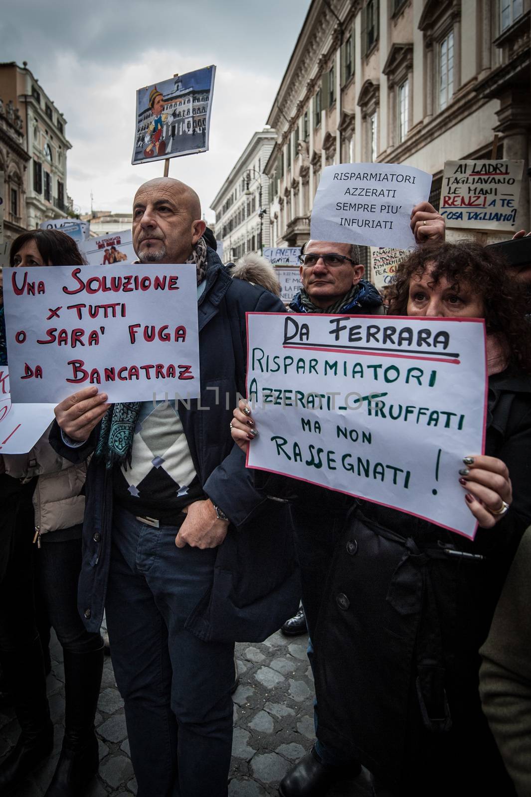 ITALY, Rome: As Italy's economy struggles in the face of a banking crisis, protesters fill the Piazza Santi Apostoli in Rome on January 31, 2016. They voice their fears about the state of their savings.Woman's sign at right rights: Investors zeroed - cheated but not resigned.