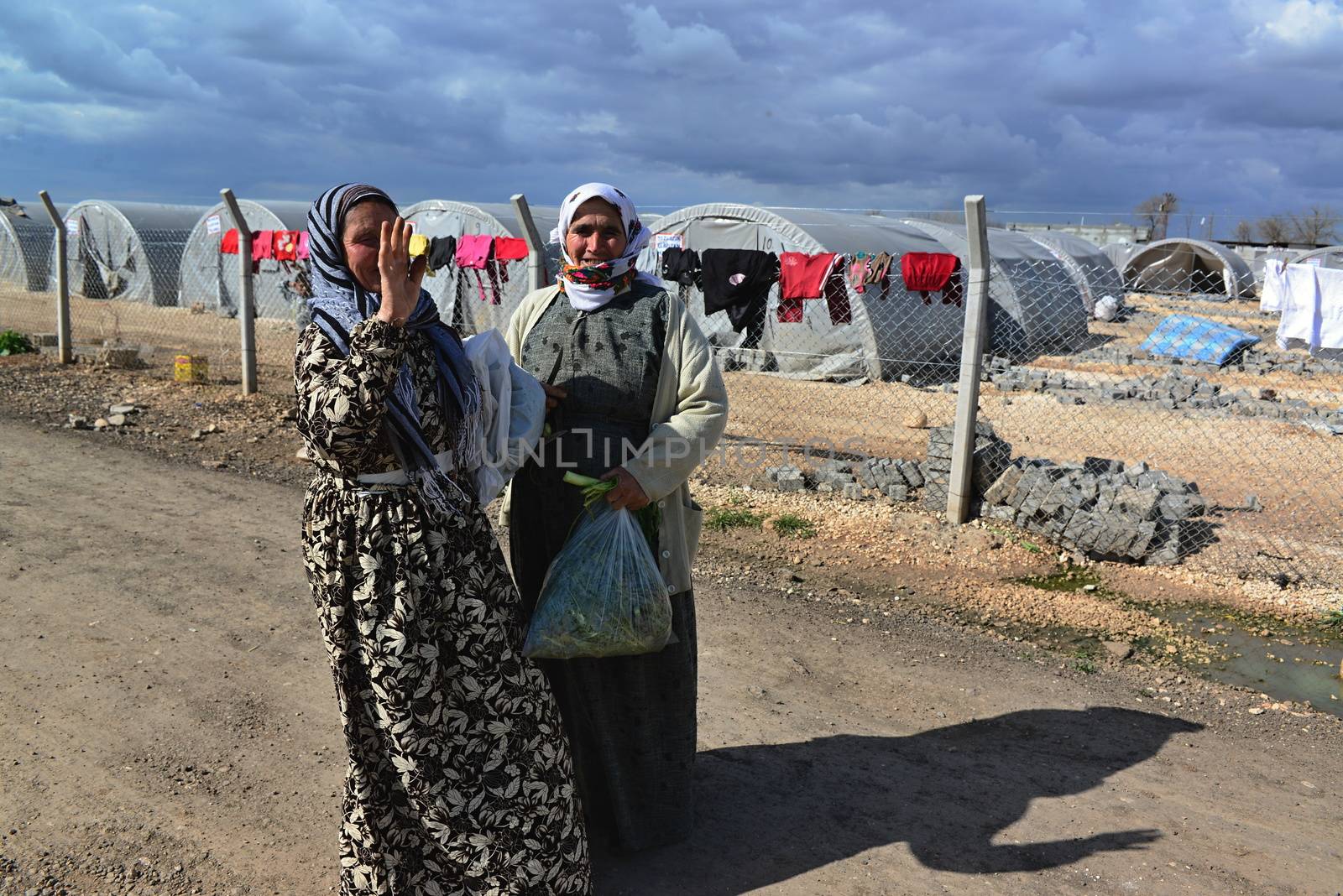people in refugee camp by radekprocyk