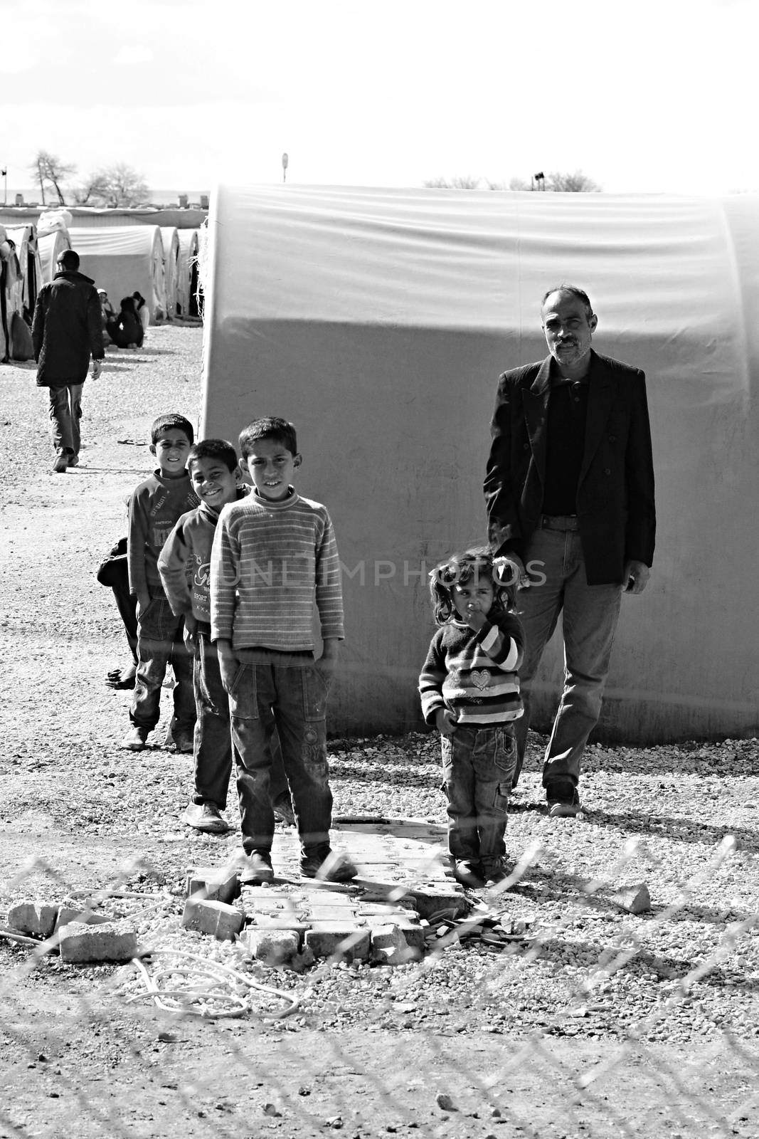 people in refugee camp by radekprocyk