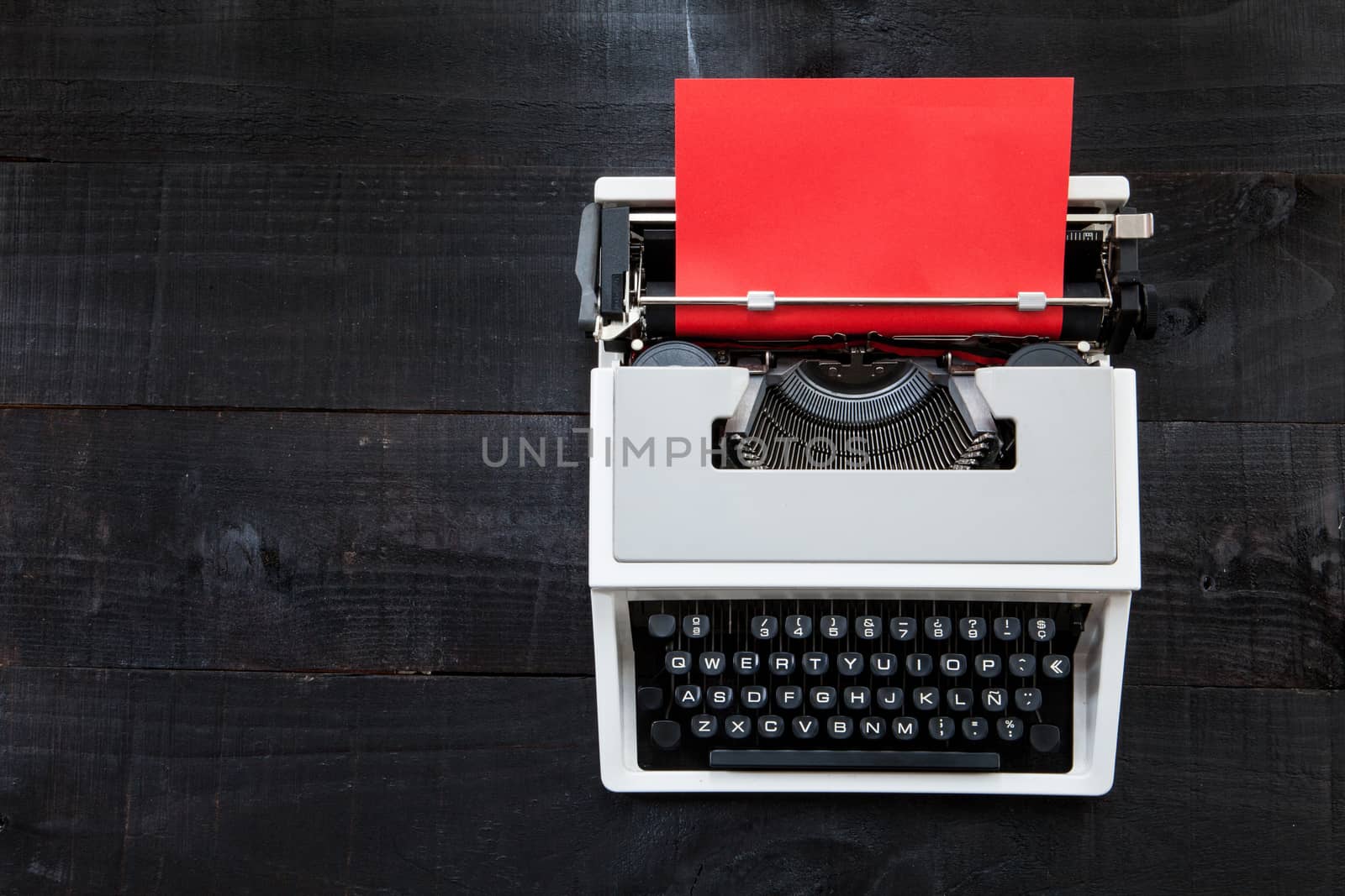 Typewriter and red paper by andongob