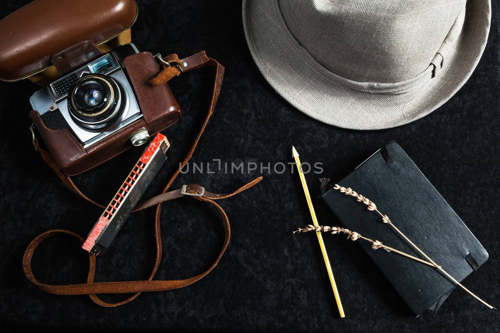 The image represents a set of objects related to photography on wooden background