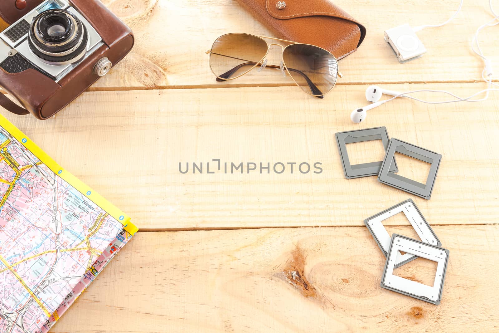 The image represents a set of objects related to photography on wooden background