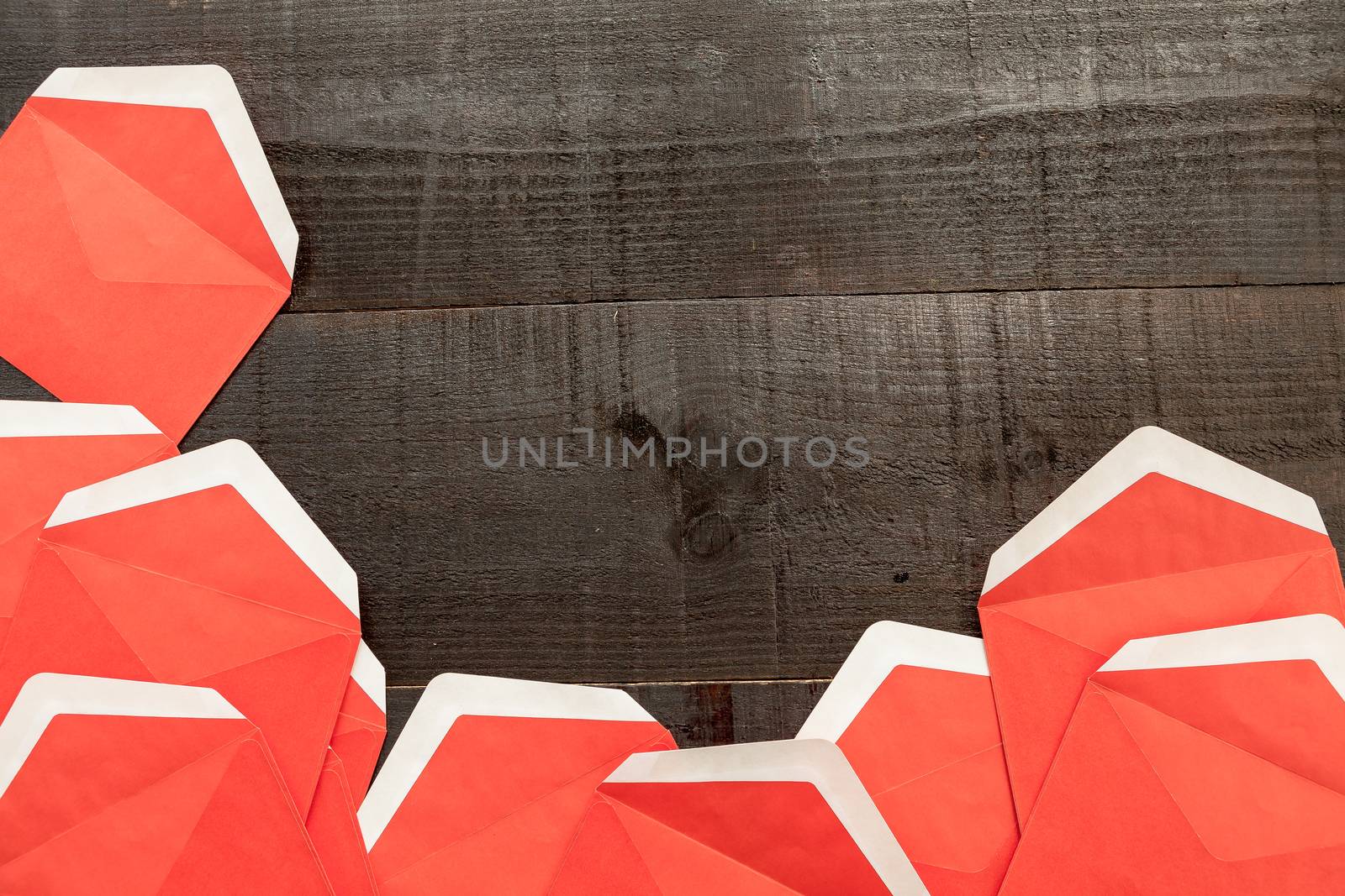 The image shows open red envelopes on wooden background