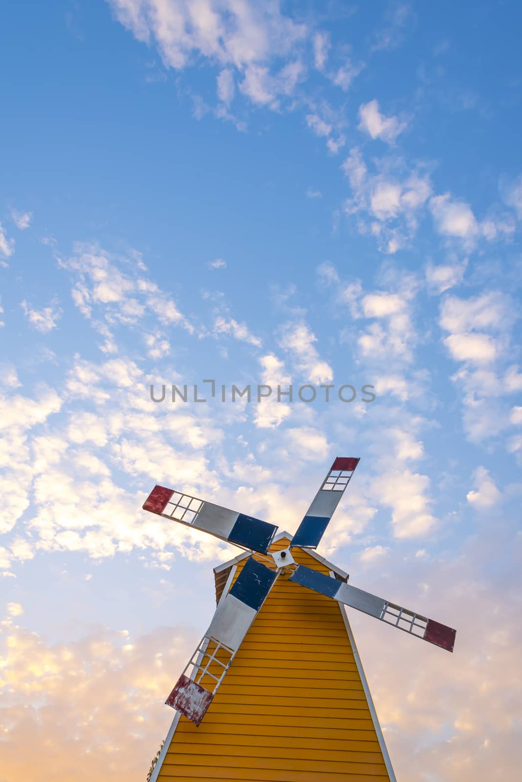 Windmills house on sunset sky background