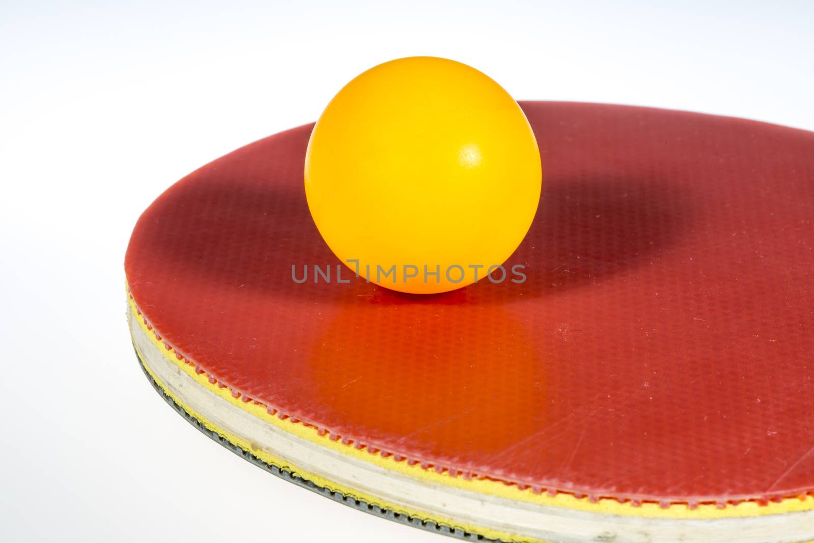 Table Tennis Ball and Paddle on white background.
