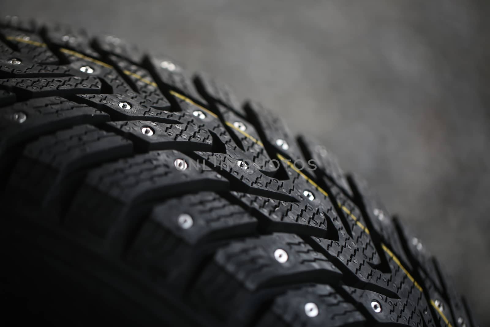 Studded tire on a gray background by everelative