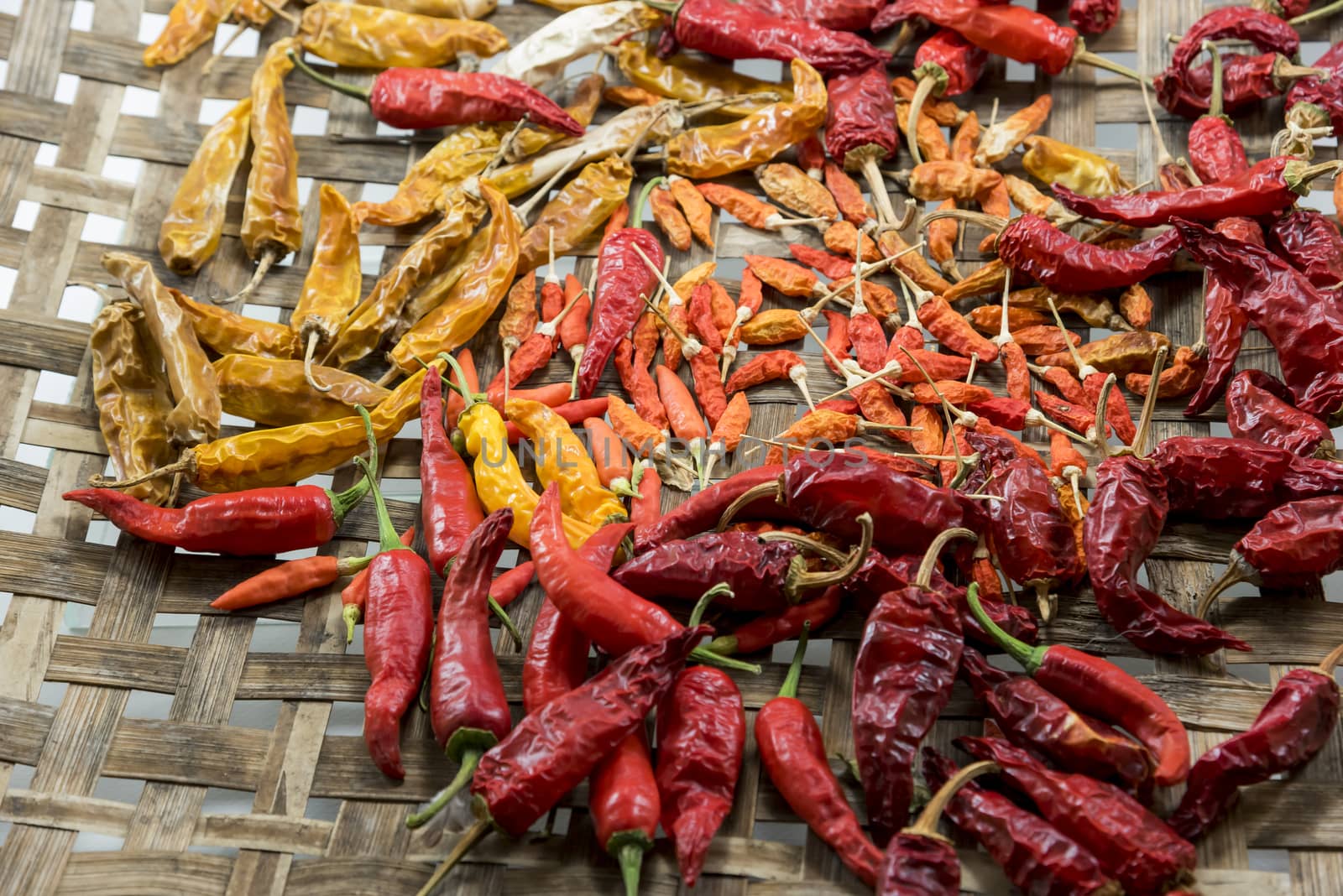 Red and yellow Dry chili pepper on bamboo basket