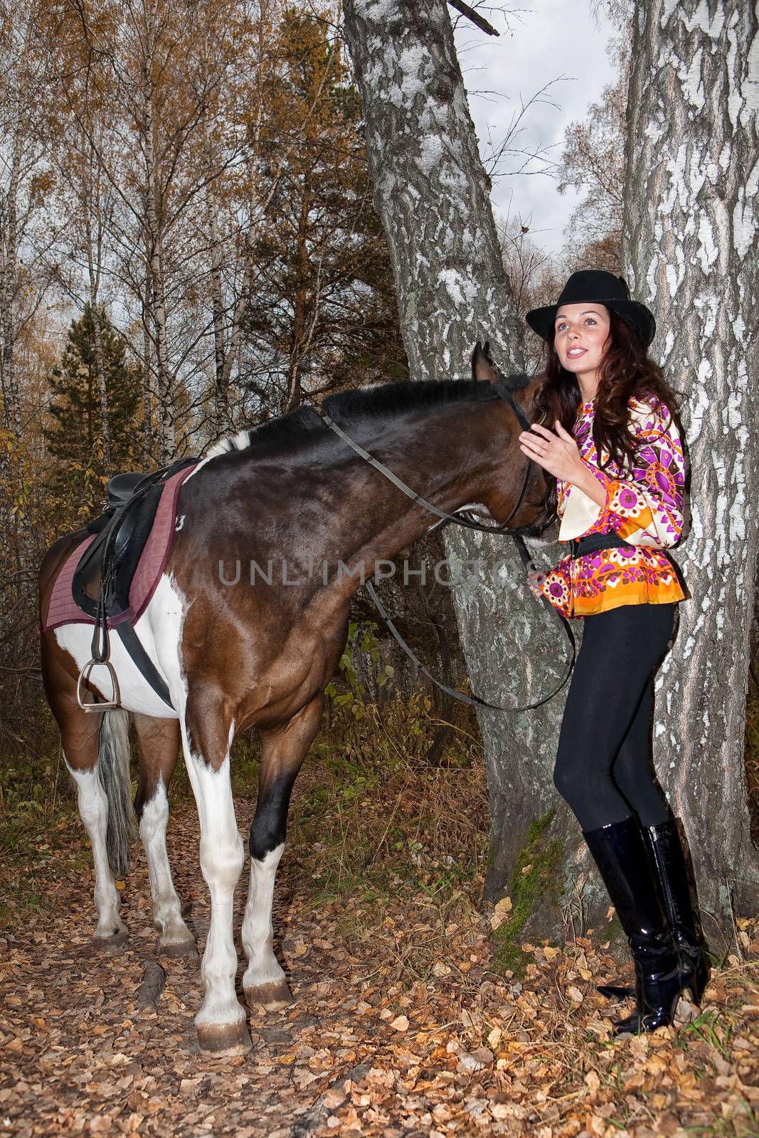 Young woman and horse in a forest