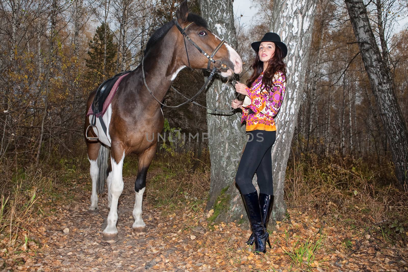 Young woman and horse in a forest