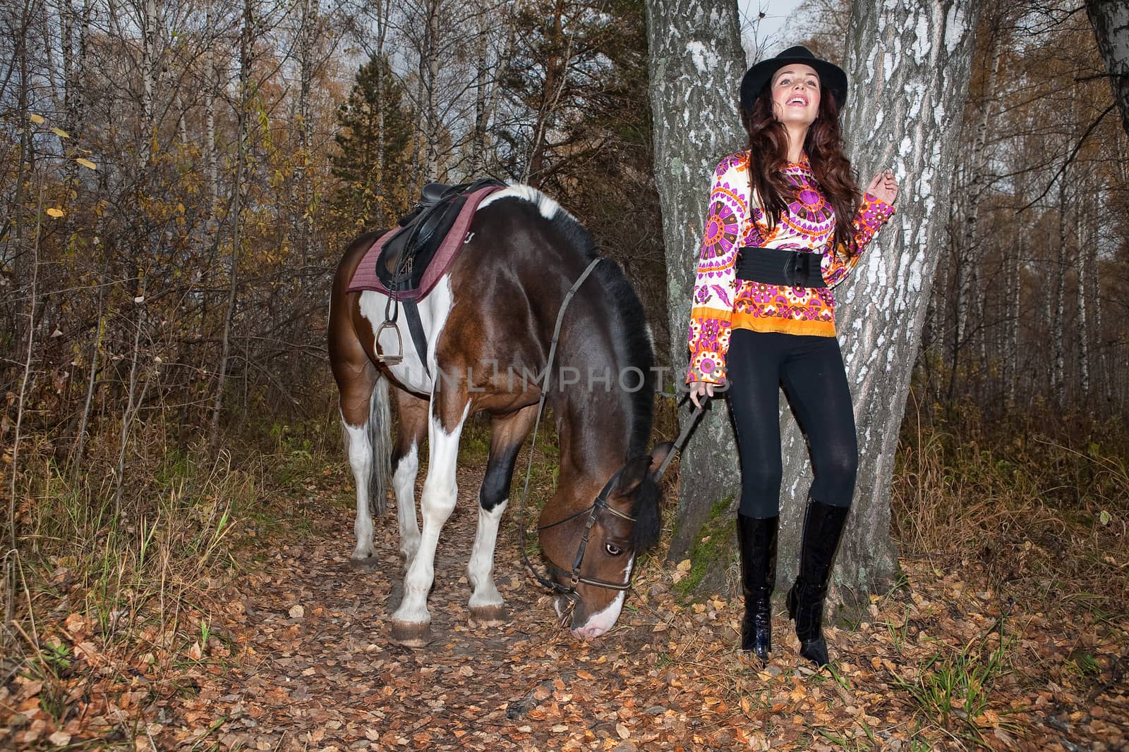 Young woman and horse in a forest