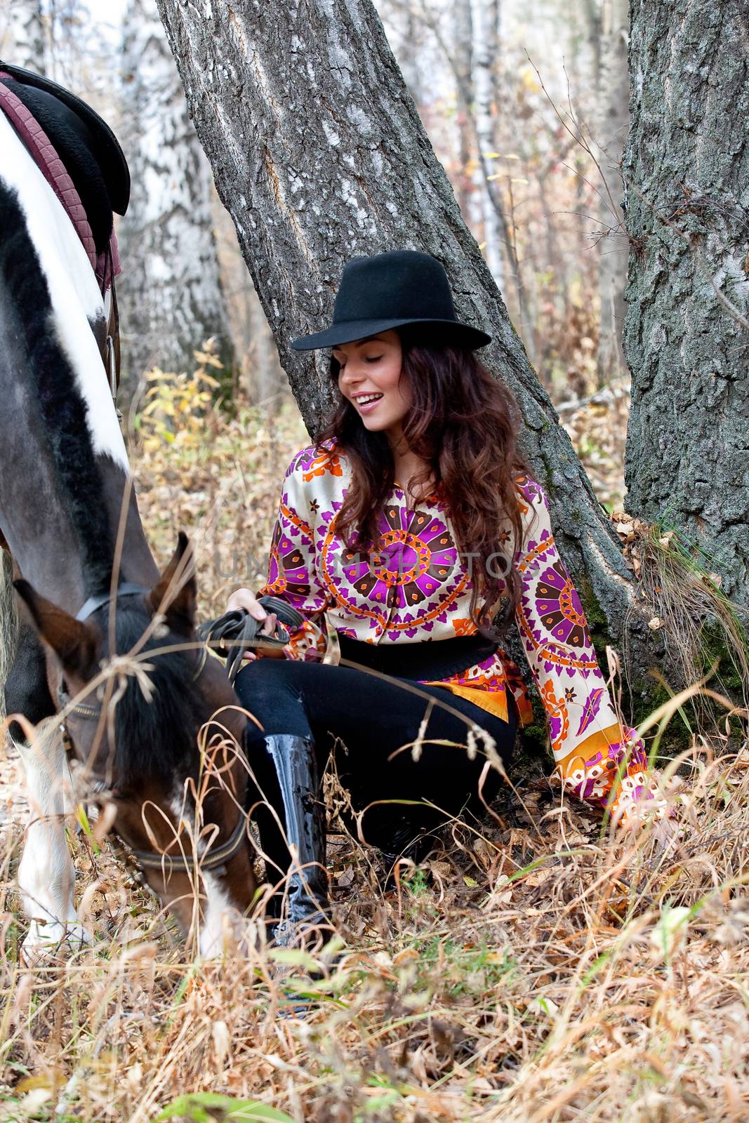 Young woman and horse in a forest