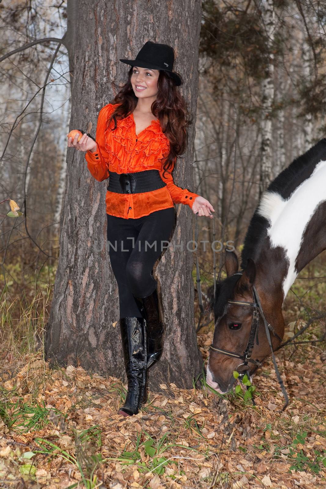 Young woman and horse in a forest