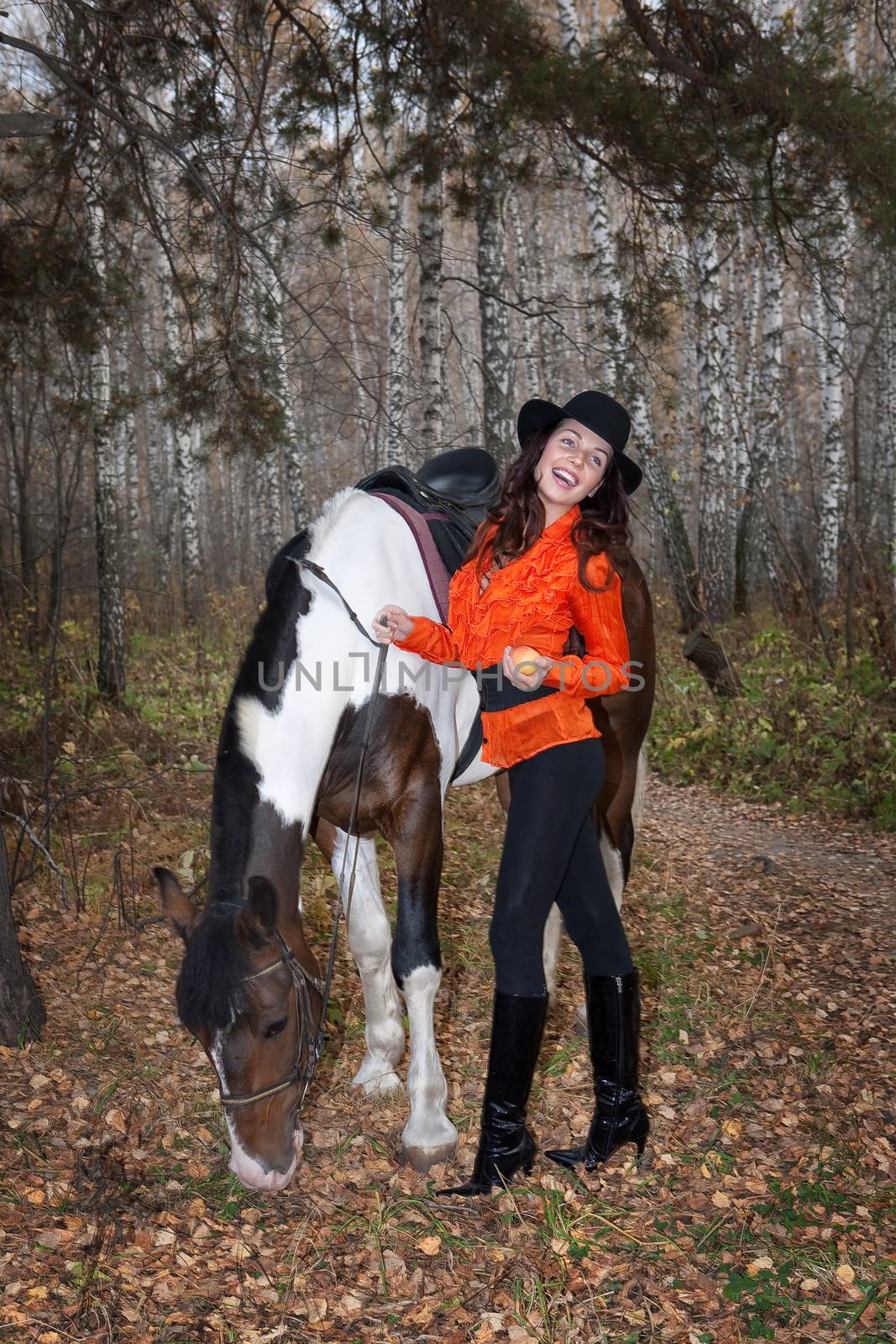 Young woman and horse in a forest