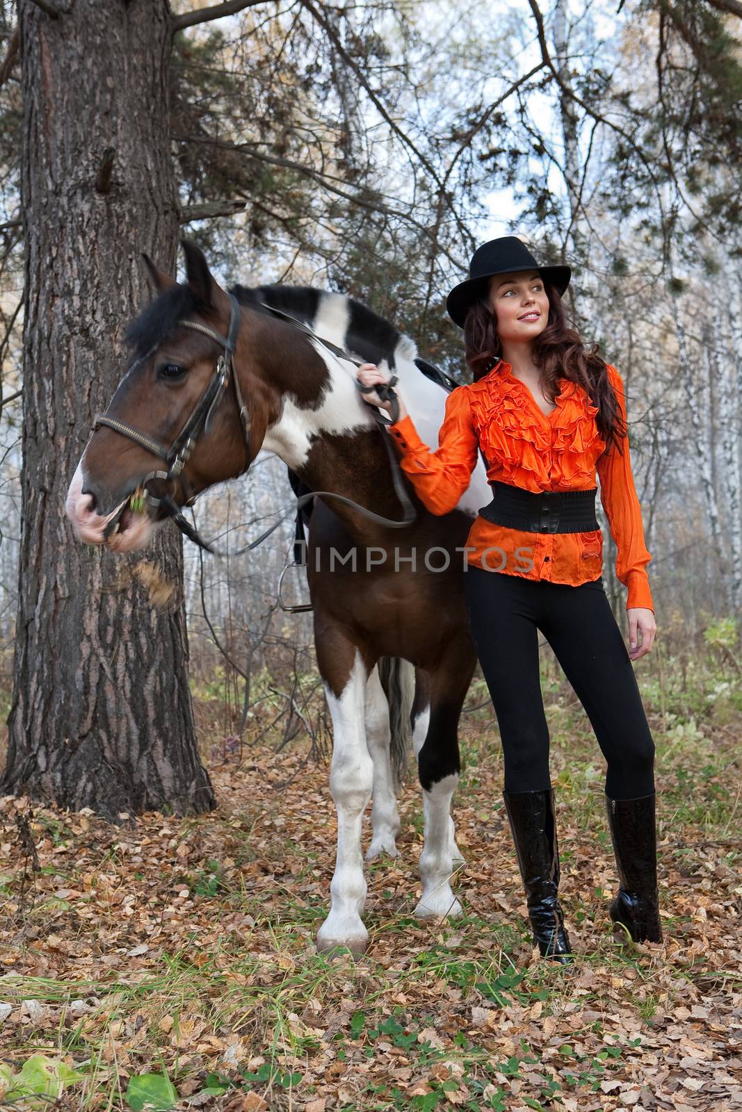 Young woman and horse in a forest