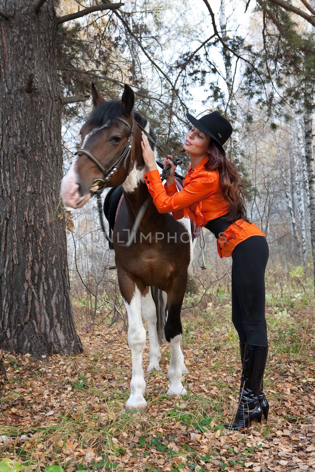Young woman and horse in a forest