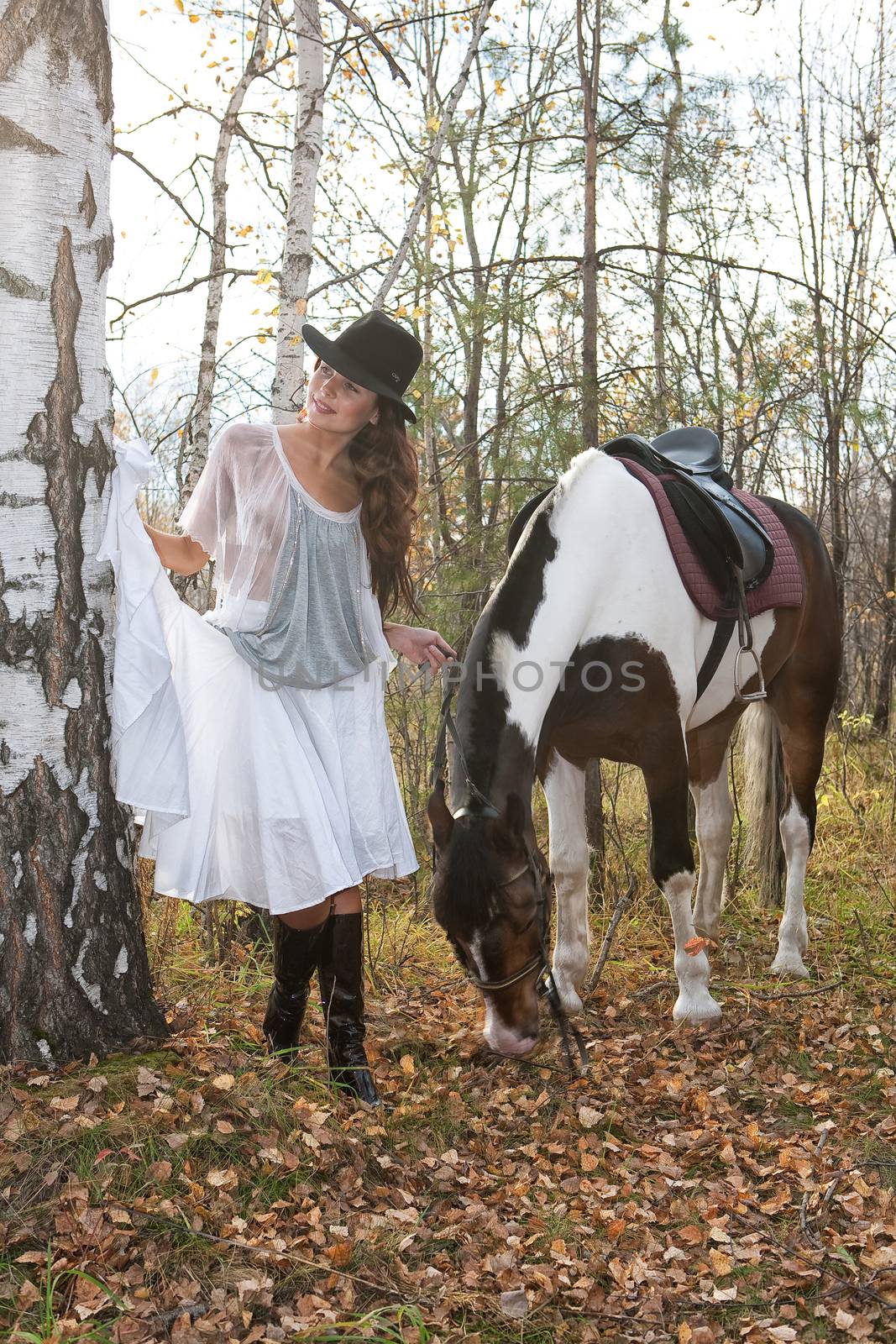 Young woman and horse in a forest