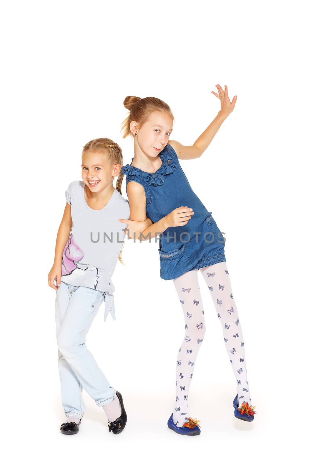 Two cute little girls hugging with a charming smile