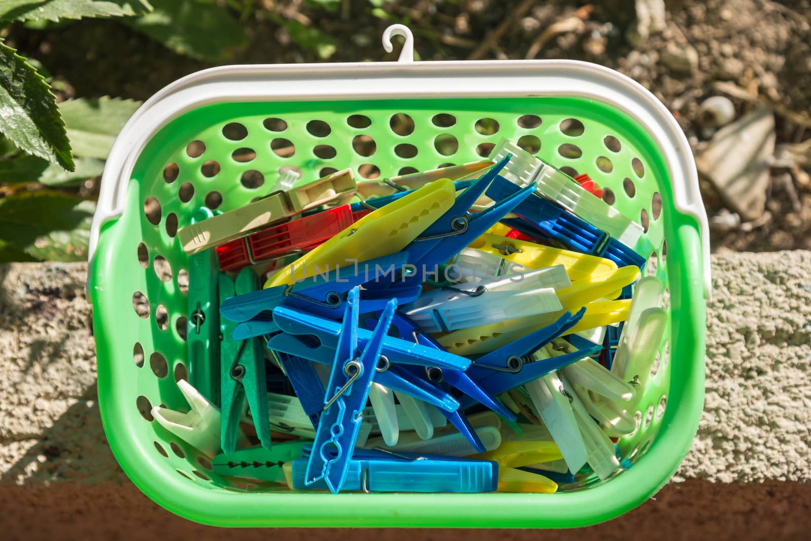 the colored plastic clothespins in a basket