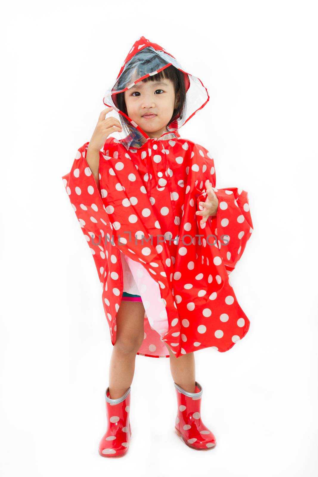 Chinese Little Girl Wearing raincoat and Boots in plain white isolated background.