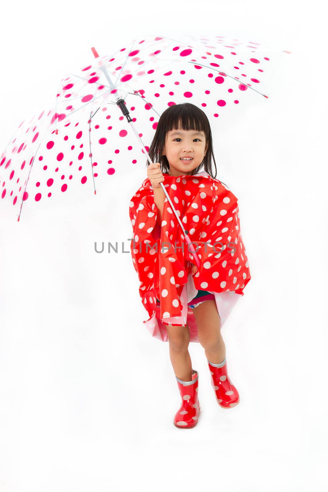 Chinese Little Girl Holding umbrella with raincoat in plain white isolated background.