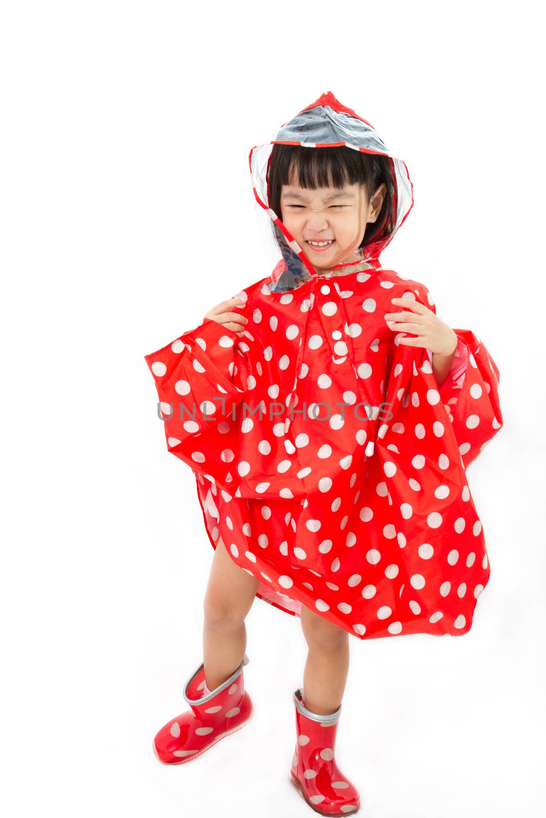 Chinese Little Girl Wearing raincoat and Boots in plain white isolated background.