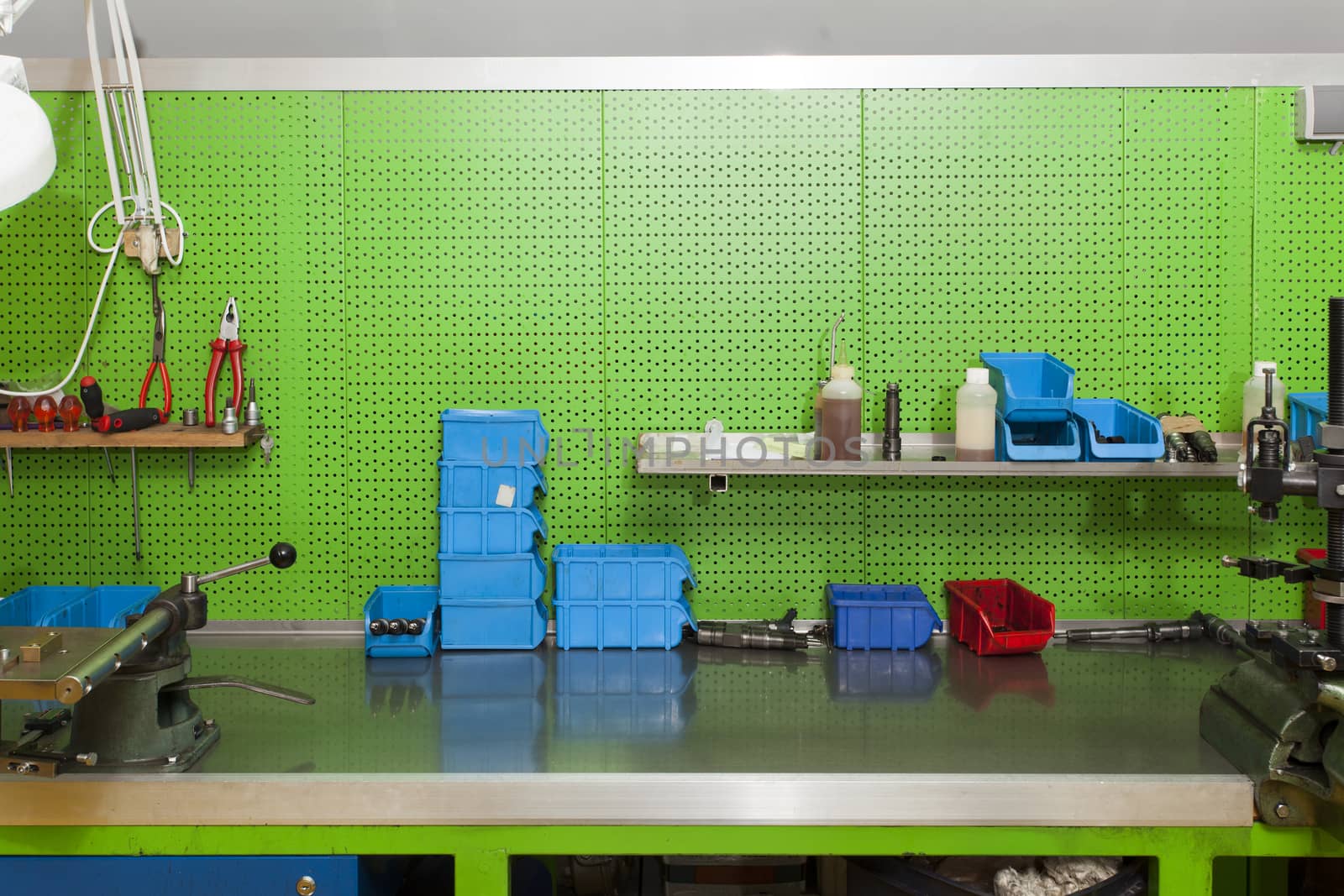 Workshop wall where all parts are organised in boxes