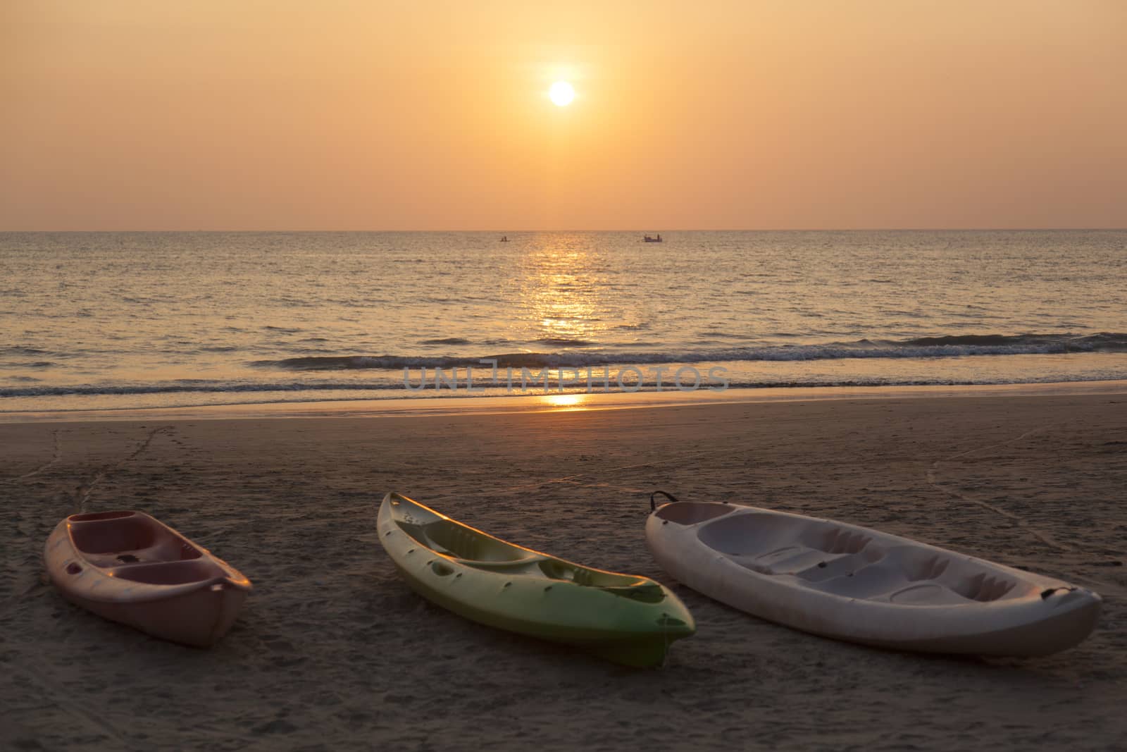 A view at the boats at the beach at sunset.