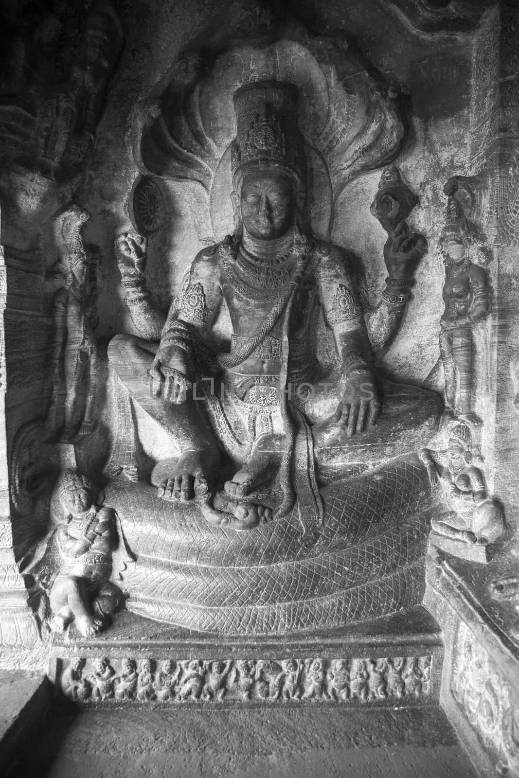 Cave temple cut out from the rock at Badami, India - relief cave entrance in black and white