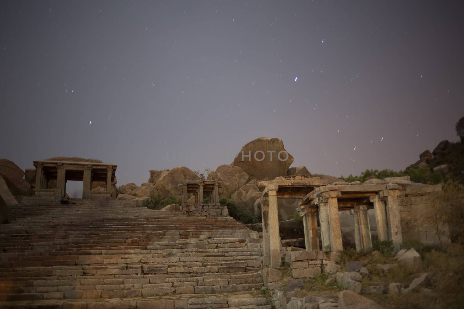 Ruins at night, opposite to Virupaksha - Vijayanagar Temple - at Hampi temple complex in India, real stars with sky movement