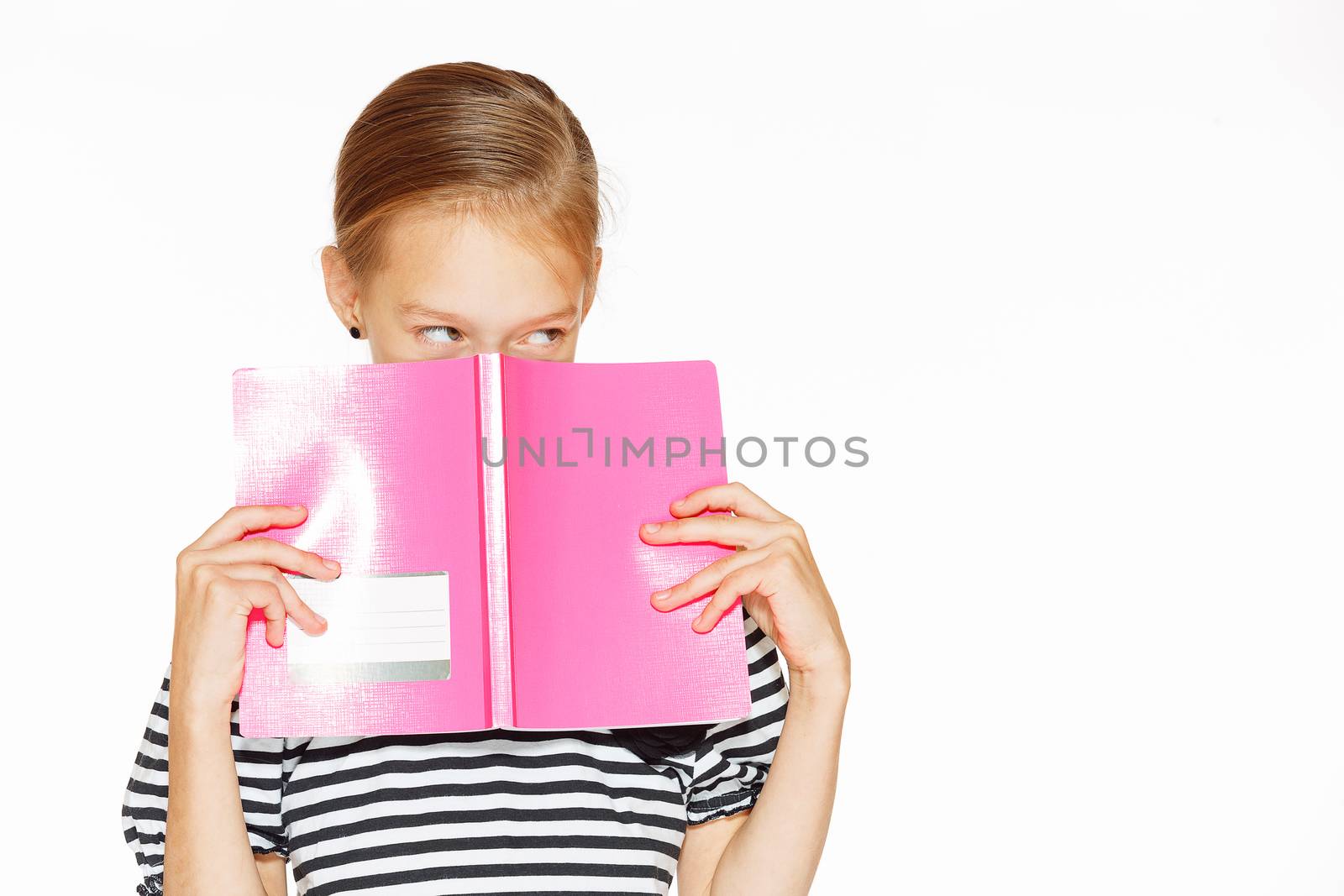 Beautiful little girl in blue dress with copybook. Isolated on white.