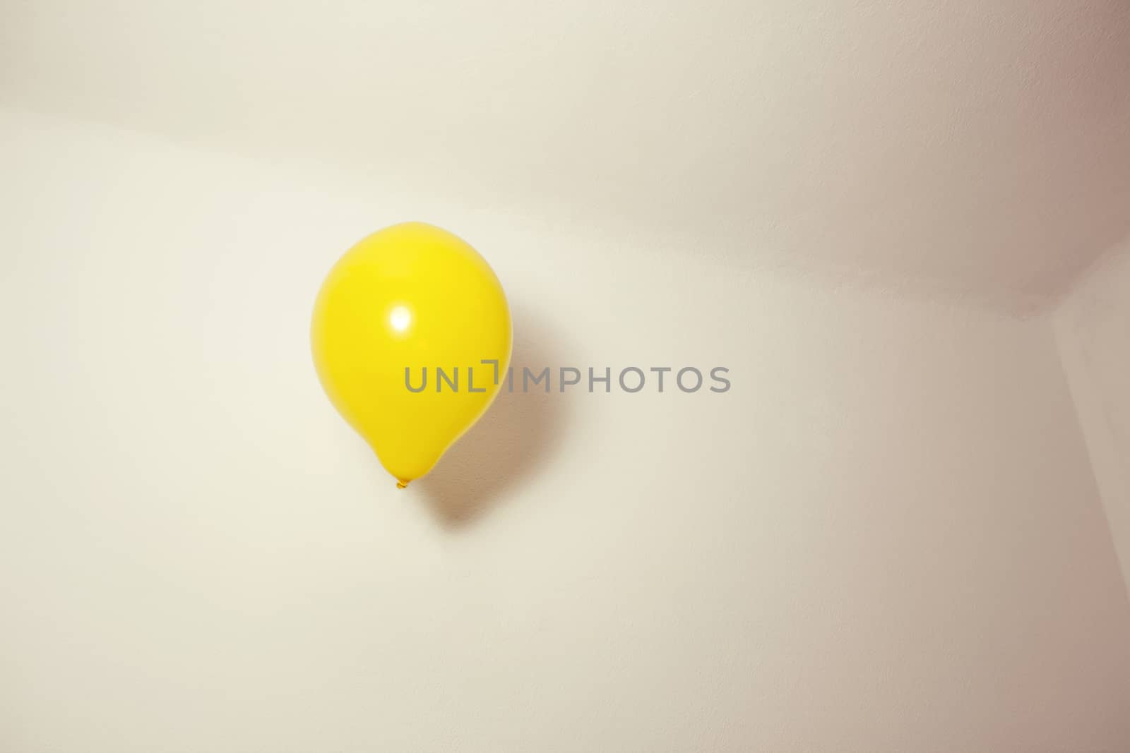 Yellow Ballon flying indoors.