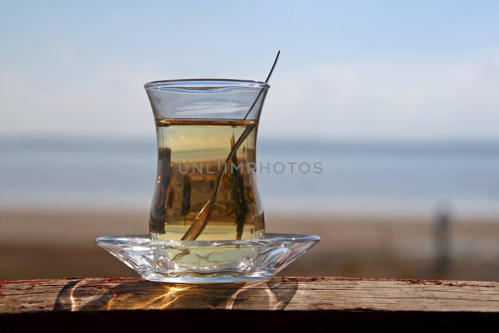 A glass of turkish tea by the sea