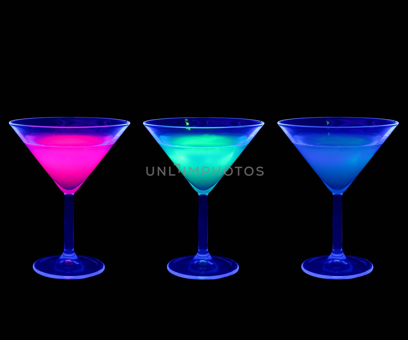 Colorful cocktail glass in UV light (black light)