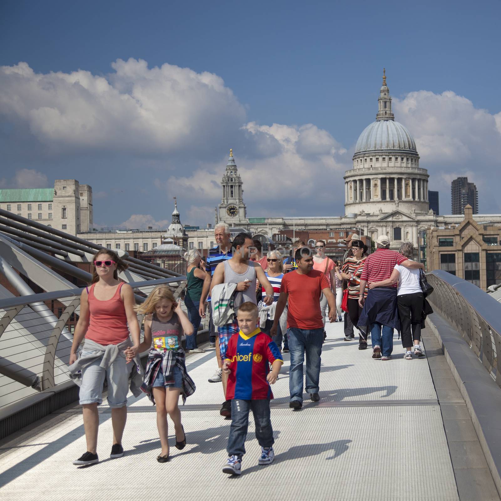View on St Paul's Cathedral in London from Millennium bridge crowded with people.