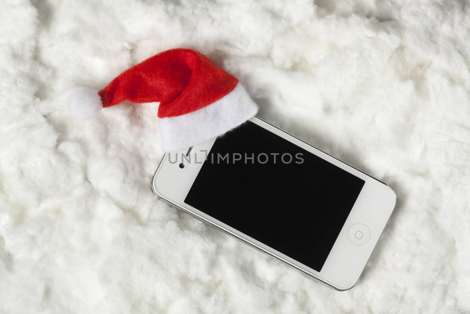 Cellphone with santa hat surrounded by white cotton