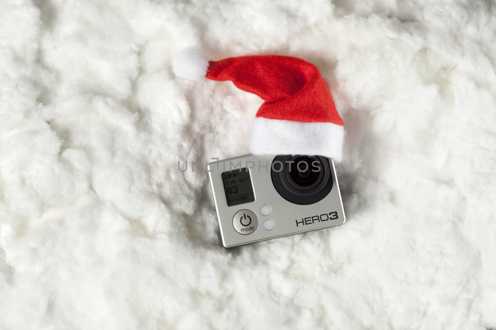 High angle view of camera on cotton with santa hat