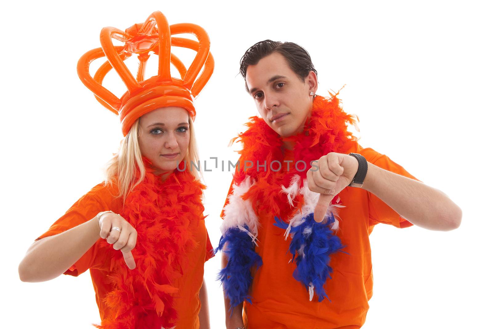 Couple of Dutch soccer supportersfeeling down over white background