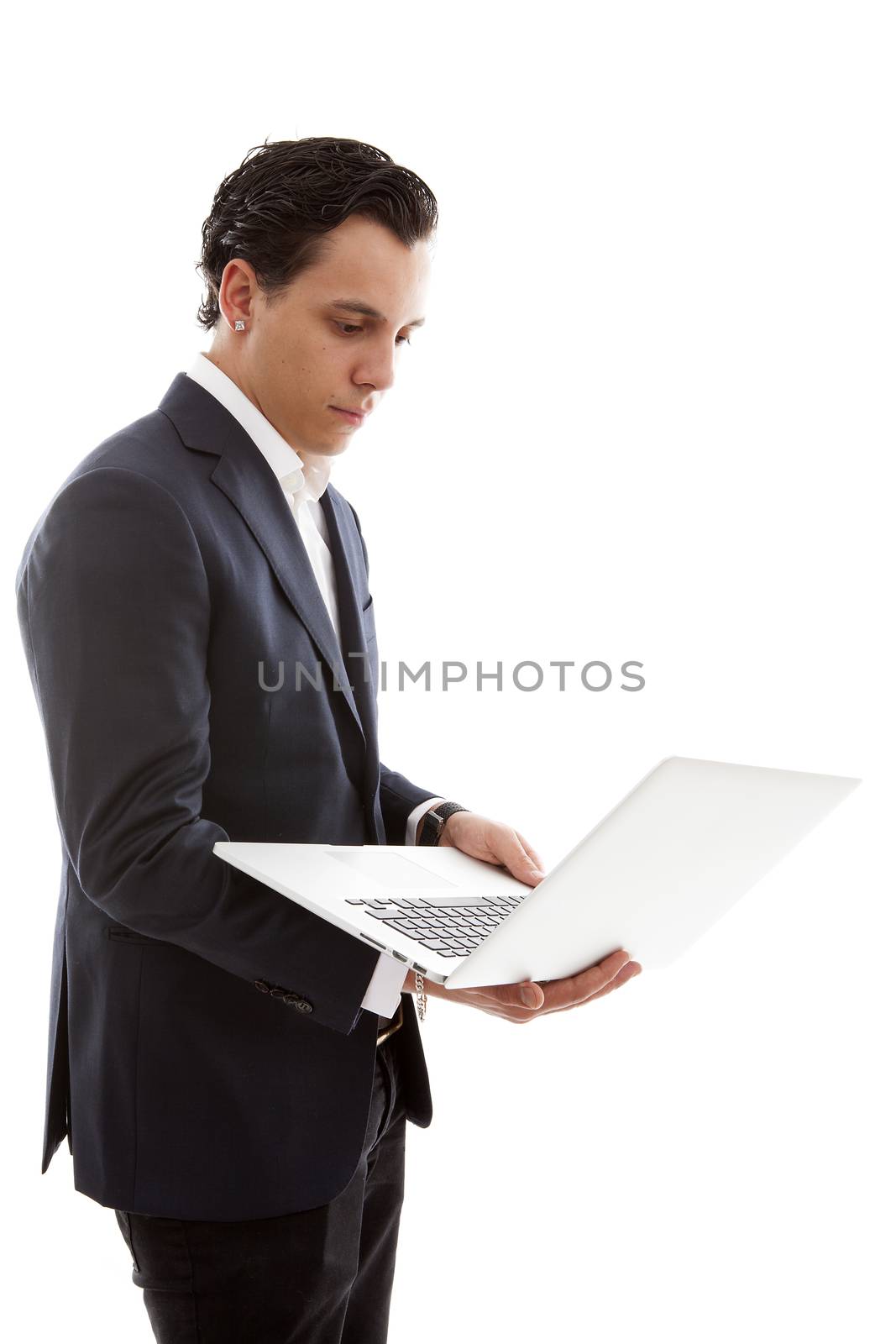 Young businessman is holding laptop over white background