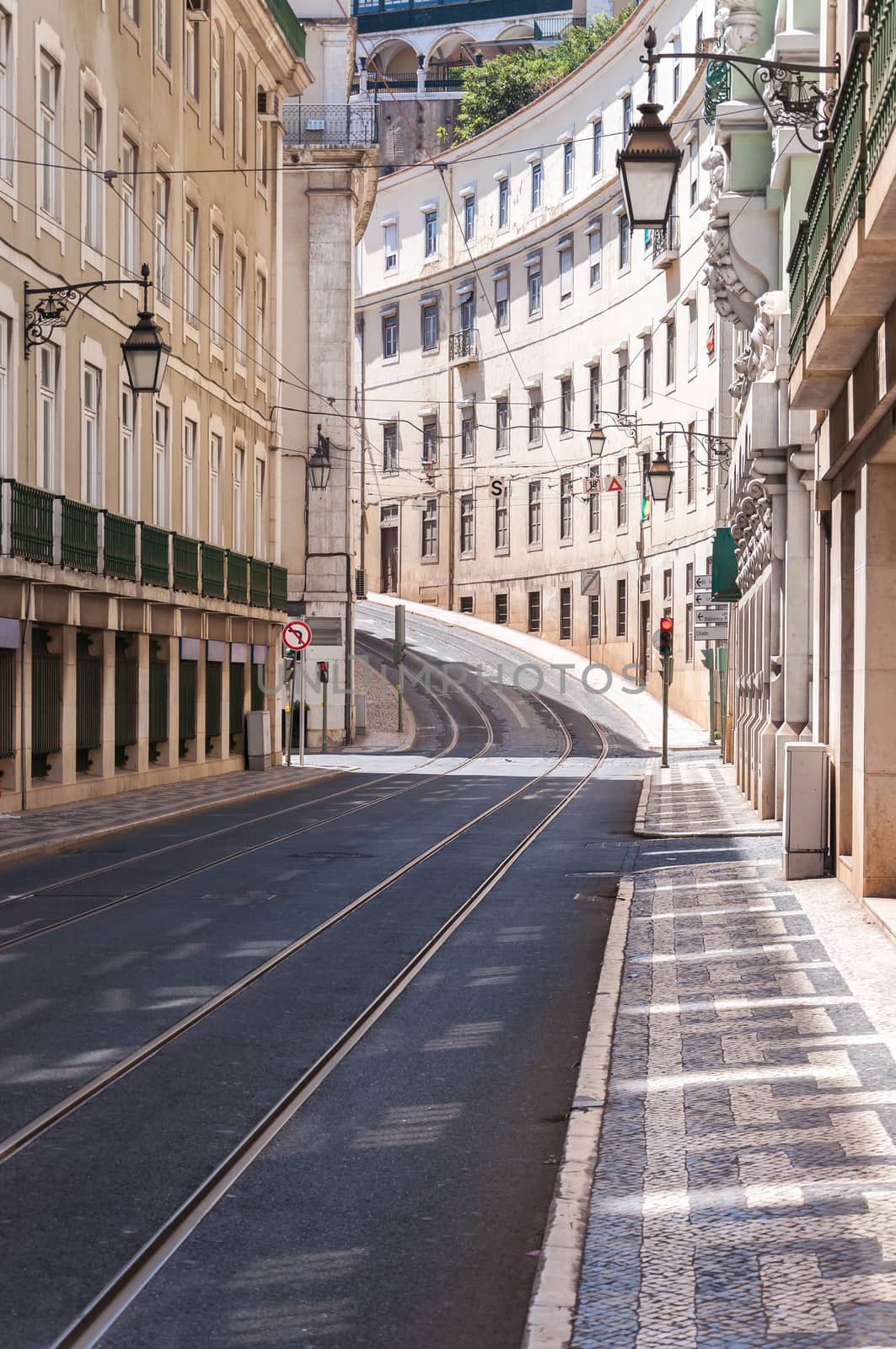 Empty street in Lisbon downtown with tramway track