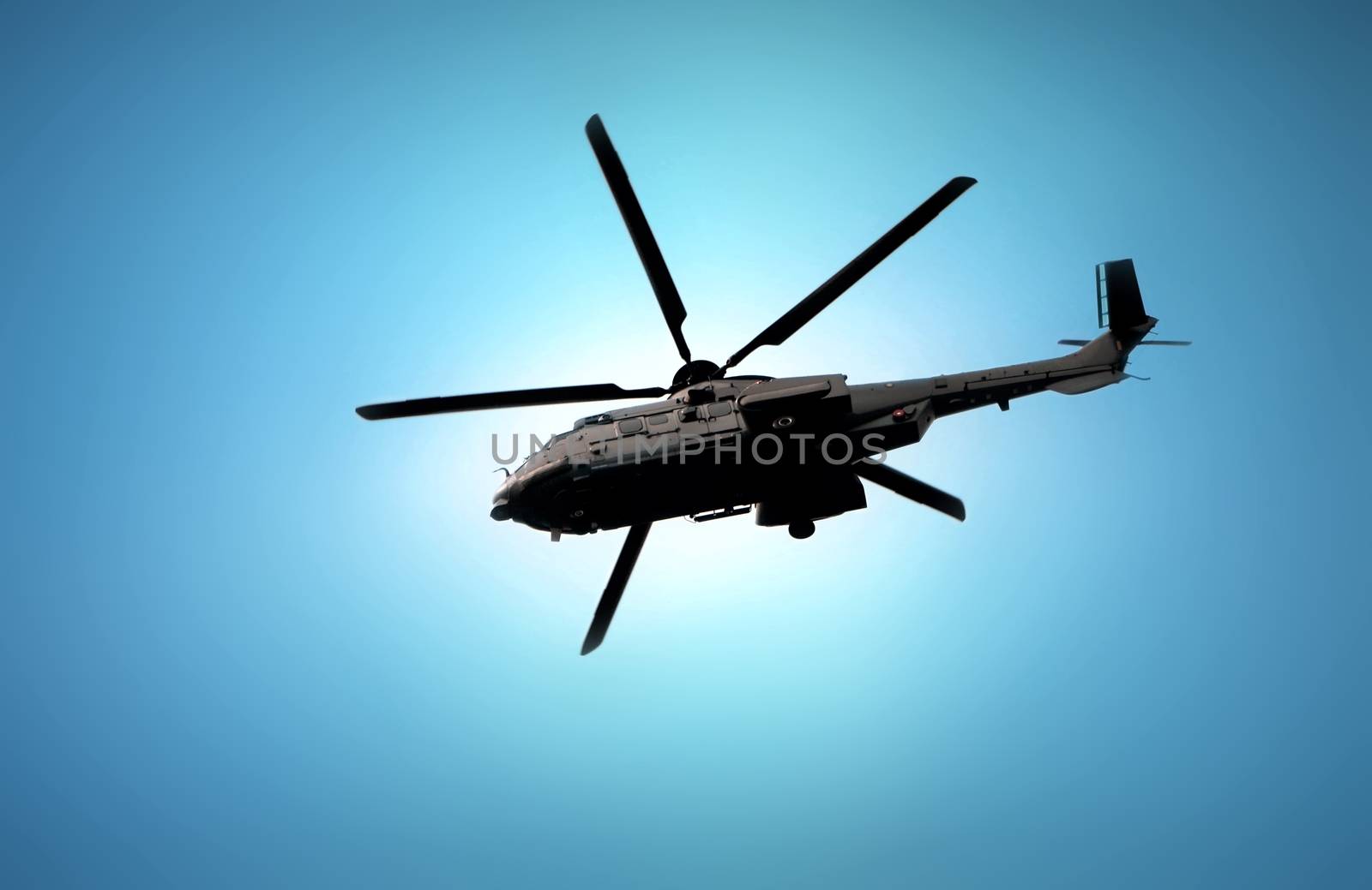 Military helicopter flying under blue sky by razihusin